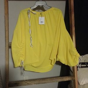 Yellow shirt with black ribbons